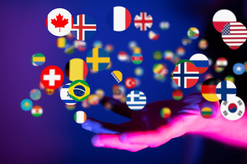 Image of a hand holding various national flags, symbolizing global connections and international...