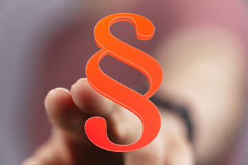 Close-up of a finger touching a 3D rendered paragraph symbol. Perfect for legal, law, and contract...