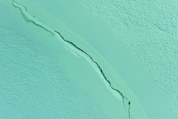 Green wall texture background. Crack wall texture. Cracked concrete wall covered with cement surface background.