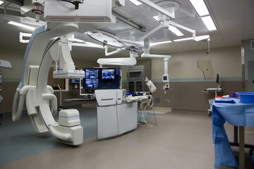 Modern operating room with integrated imaging technology, surgical monitors, and prep table setup...