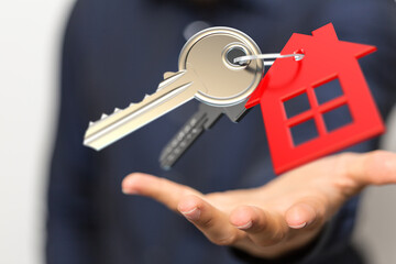 Image of house keys and a small red house floating above an open hand.  Perfect for real estate,...