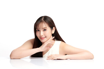 Fototapeta premium A beautiful young Asian woman with clean, fresh skin against a white background. Skincare, facial treatment, cosmetology, beauty, and spa. An elegant portrait of an Asian woman.