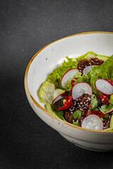 Fresh vegetable salad of green lettuce, radish and cucumber with dill, green onions and greek yogurt