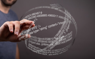 A person interacts with a digital sphere displaying lines of code, representing data and technology.