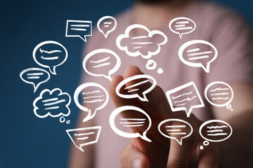 Hand interacting with floating speech bubbles,concept of communication, ideas, and collaboration.