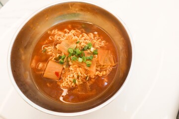 close up of a red Korean kimchi soup instant noodles in a bowl