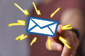 Close-up of a hand interacting with a digital email icon, highlighting new message alert.
