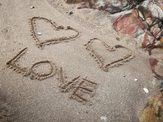 Hearts love drawn on sand beach