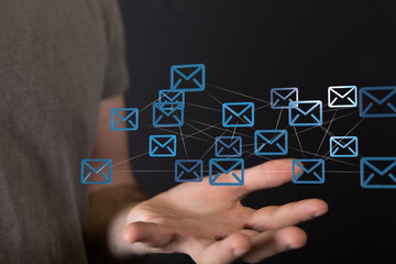 Hand holding interconnected email icons,digital communication, network, global connection.