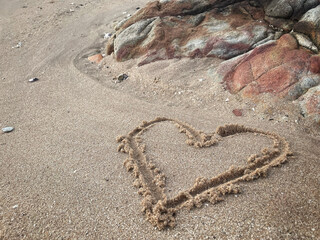 Hearts drawn on sand beach