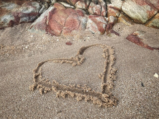 Hearts drawn on sand beach