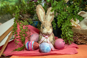 Easter Bunny with Colorfully Painted Eggs and Greenery on a Festive Table