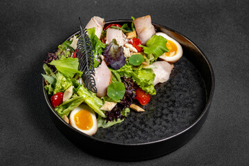 Plate of Fresh Green Salad with turkey ham, mozzarella and tomato isolated on white background