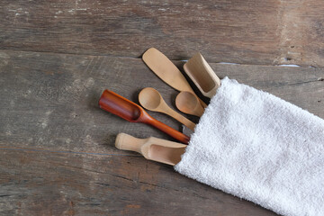 Set of wooden spoons are different kinds in towel on wooden.