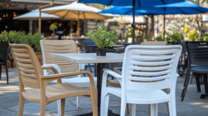 Serene Outdoor Cafe: Table with Chairs, Plant, Umbrellas - Perfect for Leisure, Relaxation, and Enjoying the Summer Atmosphere in a Stylish Setting