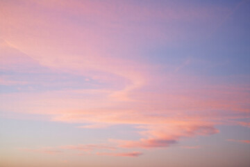 Fototapeta premium Gentle pastel sky with soft pink and blue clouds at sunset, creating a dreamy and ethereal atmosphere, perfect for backgrounds and serene landscapes