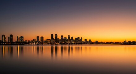 Fototapeta premium City skyline at sunrise over water
