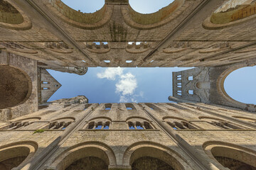 Looking vertically up in the ruined church of Jumieges Abbey with no roof above the church