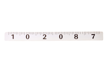 Close-up of a transparent plastic ruler with black measurement markings on a white background for precise length measurement and drawing guides