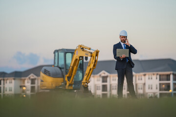 Construction manager in suit and helmet at a construction site. Construction manager worker or...