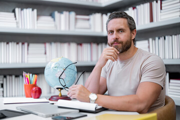 Teacher in classroom. Knowledge and education with handsome teacher. Teacher with book in classroom. Man on lesson in class. Teachers from university exam. College teacher. Teaching in university.