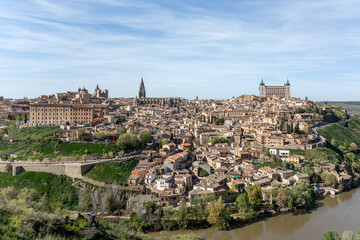 panoramic view of toledo’s historic center with the alcázar, cathedral, and monuments surrounded by the tagus river, showcasing spain’s imperial heritage