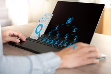 Business man  seek data to find a human data which are floating on screen