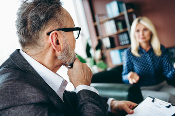 Businessman and businesswoman engaging in an office discussion, teamwork and collaboration concept...