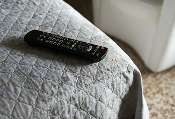 tv remote control on the bed