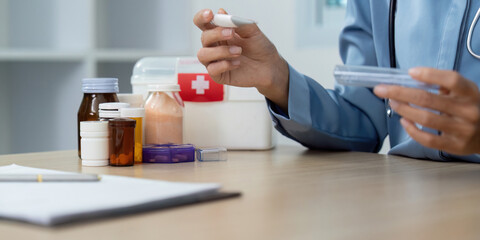 Medication Management. Healthcare provider holding medication and thermometer during checkup.