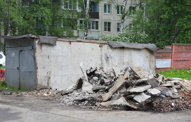 Demolition of old concrete garages in the courtyard of an apartment building, Iskrovsky Prospekt, Saint Petersburg, Russia, May 29, 2025