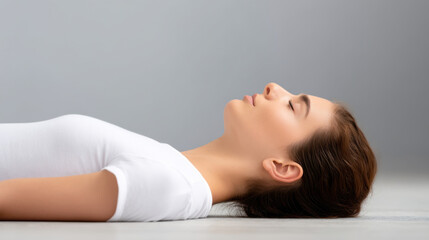 Obraz premium Self healing concept. Relaxed woman lying floor with eyes closed, enjoying calm and peaceful moment, indoor setting