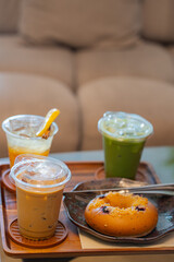 Close up glass of ice coffee and ice matcha green tea on wooden tray of a coffee shop summer terrace, menu photography.