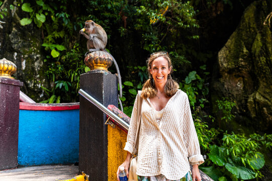 Female influencer with monkeys on colorful stairs