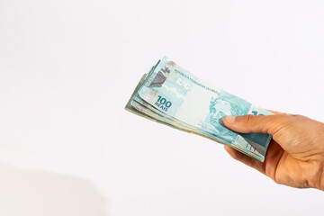 Hands of a Man Holding 100 Brazilian Bank Notes Reais