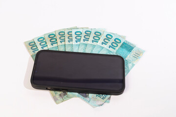 Black Cellphone and Brazilan 100 Reais Banknotes on a white background