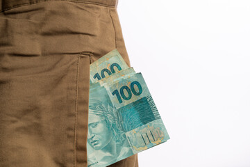A Man With Brazilian 100 Reais Banknotes on his pocket on white background
