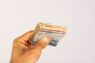 Hands of a Man Holding Brazilian Bank Notes Reais ready to pay