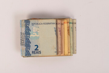 All Brazilian Bank Notes Reais on a white desk