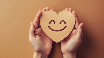 paper cut smiley face in hands make heart symbol for protection around on beige background. positive thinking, mental health, assessment, world mental health day concept