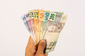 Hands of a Man Holding Brazilian Bank Notes Reais ready to pay