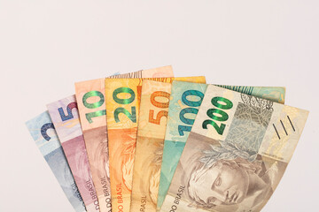 All Brazilian Bank Notes Reais on a white desk
