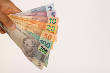 Hands of a Man Holding Brazilian Bank Notes Reais ready to pay