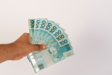 Hands of a Man Holding 100 Brazilian Bank Notes Reais