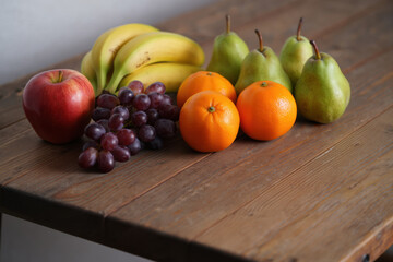 Fresh fruit assortment displayed on rustic wooden table