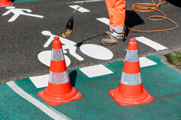 Road workers marking cycle paths