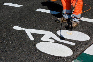 Road workers marking cycle paths