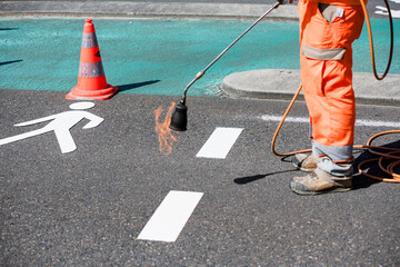 Road workers marking cycle paths
