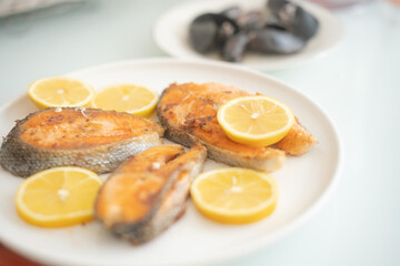 fried salmon fish with lemon plate close up