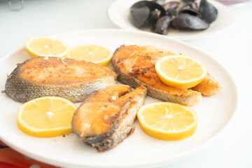 fried salmon fish with lemon plate close up